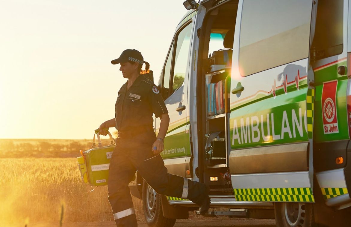 a paramedic stepping out of an ambulance
